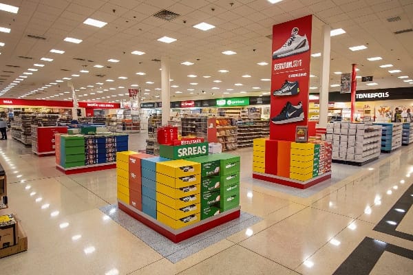 Les étalages à chaussures colorés avec des boîtes soigneusement arrangées dans un grand magasin de détail.