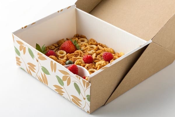 Cardboard cereal box with oats, berries, and granola inside