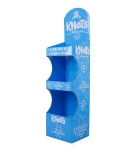 A custom-printed blue 3-tier cardboard display for KNOTS mini pretzels featuring a curved side profile and white branding.