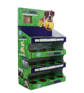 A 4-shelf custom printed cardboard display for Interball dog toys featuring grass-themed graphics and a dog illustration.