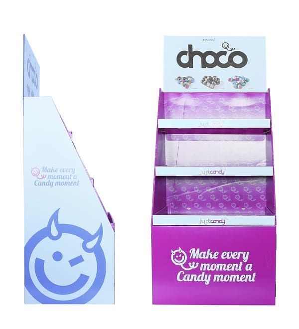 纸板POS展示架的侧面图和正面图，显示了倾斜的货架设计和恶魔般的笑脸标志。.