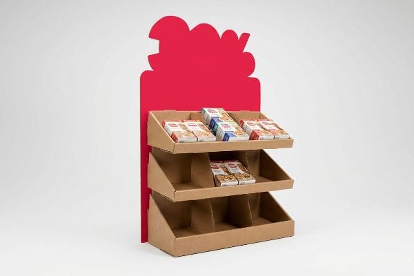 Corrugated cardboard 3-tier POP display with a vibrant red die-cut header and angled shelves showcasing snack boxes.