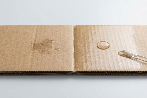 Water droplets on corrugated cardboard highlight the water-resistant benefits of aqueous coating.