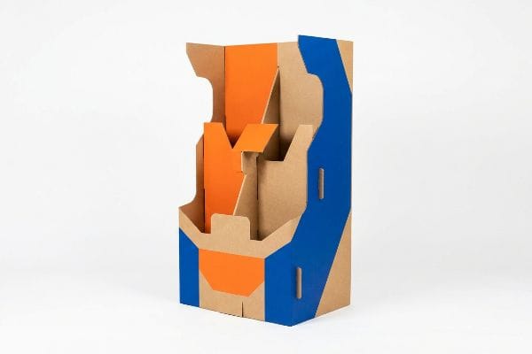 Brown corrugated cardboard retail display stand with high-contrast blue and orange die-cut panels, designed for maximum aisle visibility.