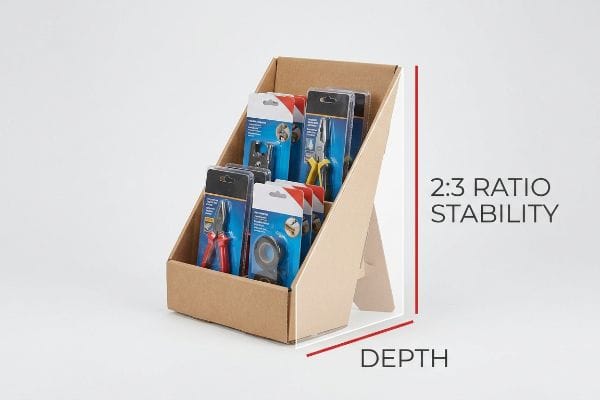 Brown corrugated cardboard countertop display stand showcasing various tools in blister packs, with text highlighting 2:3 Ratio Stability and Depth.