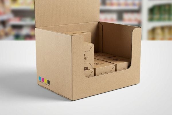 A retail setting features a brown cardboard display box showcasing products with CMYK color matching swatches and 'HUX' branding.