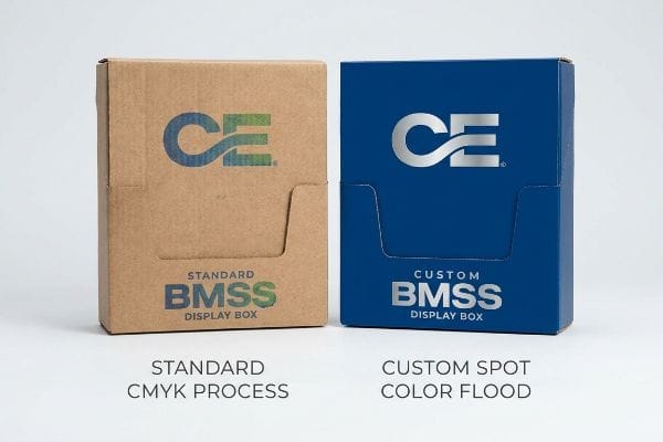 Two corrugated display boxes, one brown with Standard Cmyk Process printing, the other blue with Custom Spot Color Flood for Bmss Display Box.
