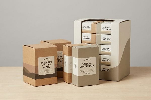 Displaying various retail packaging, including brown Premium Coffee Blend and light grey Organically Organic Snack Bars boxes, alongside a multi-pack retail display unit.