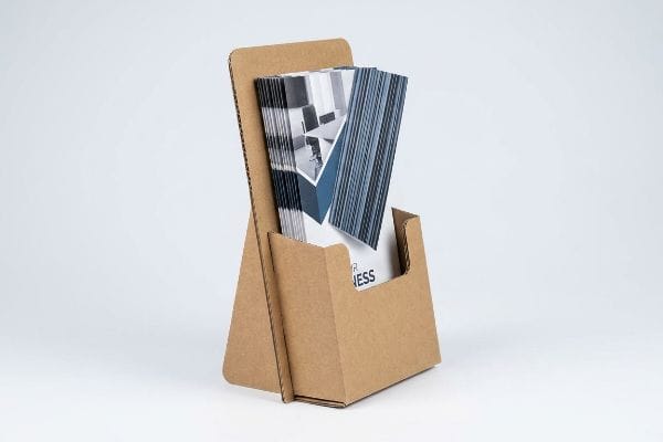 Brown corrugated cardboard brochure holder with an easel back, displaying folded literature for R Business.