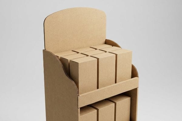 Natural kraft corrugated POP display with a curved header and wave-cut side edges, showcasing small brown product boxes.