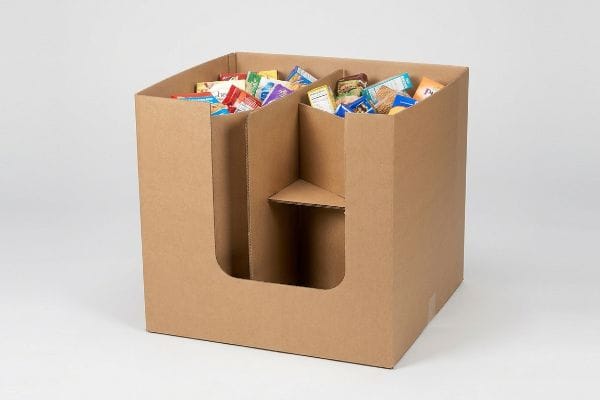 Brown corrugated cardboard dump bin with an H-divider structure and front cutout, filled with assorted packaged snacks for retail display.