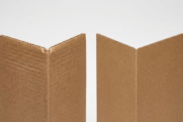 Brown corrugated cardboard pieces display distinct flute profiles and precise bend allowance for structural rigidity.