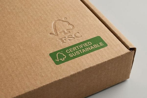Une boîte en carton ondulé brun arbore un logo FSC en relief et un autocollant vert « Certifié durable », soulignant son emballage écologique.
