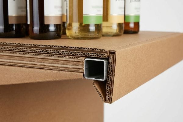 Layers of corrugated cardboard with a hidden square steel tube, providing structural support for heavy beverage bottles.