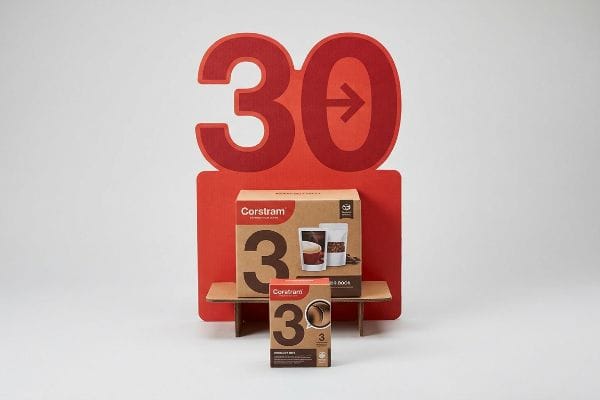 Corstram coffee product display with a large red '30' cutout, showcasing two '3' branded cardboard boxes.