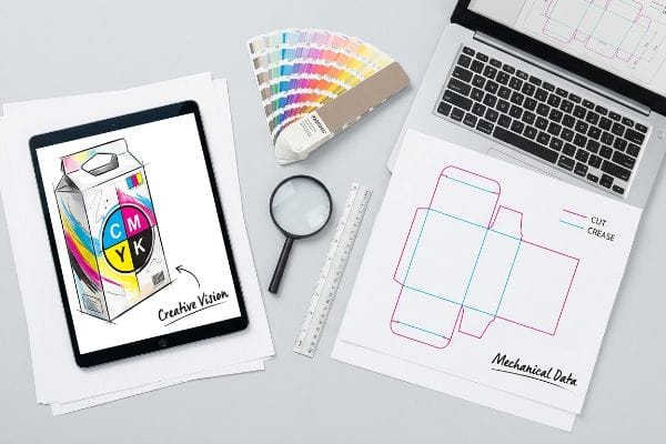 Tablet displaying Cmyk milk carton design, Pantone swatches, and a dieline with magenta Cut and cyan Crease lines.