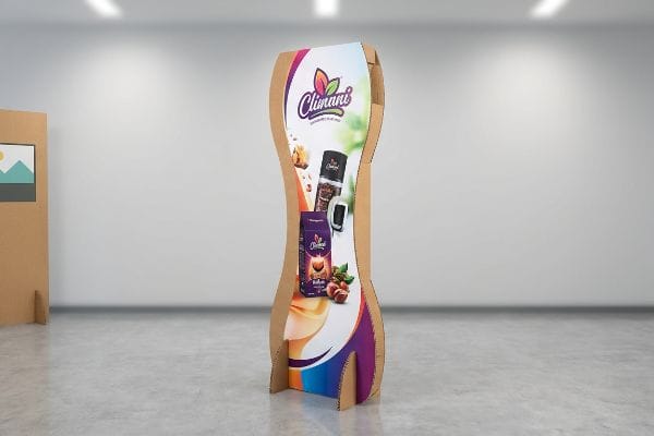 Curvy cardboard pop-up banner for Climanj coffee, featuring Robusta Hazelnut packaging and custom die-cut shape.