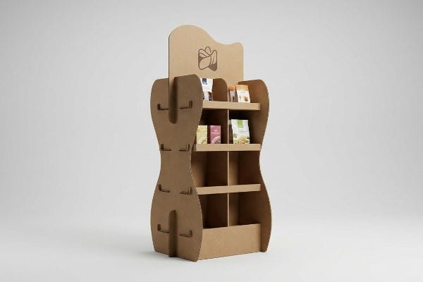 Brown corrugated cardboard display with a curvy, die-cut silhouette, showcasing small retail product packages for visual merchandising.