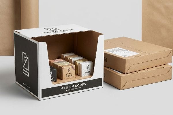 Custom retail display packaging for Premium Goods showcases Artisanal Soap boxes, with stacked shipping cartons.