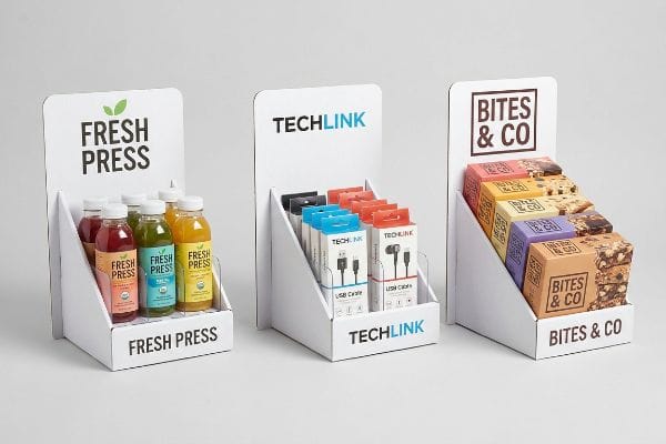 Customized counter display stands showcase Fresh Press juices, Techlink USB cables, and Bites & Co snack bars.