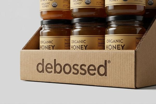 Corrugated cardboard PDQ display tray featuring the debossed