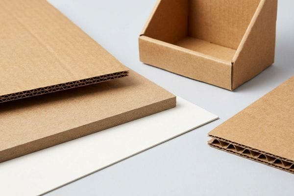 Table top display materials: single-wall corrugated cardboard with E-flute, high-density paperboard, white SBS, and an empty brown counter display.
