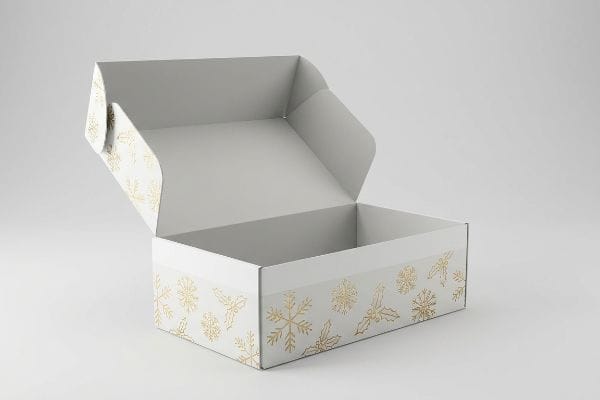 White cardboard box with gold foil embossed snowflakes and holly leaves, open to show structural exclusion zone on lid.