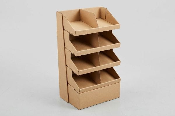 An empty four-tier brown corrugated cardboard tray floor display stands ready for products, ideal for retail merchandising.