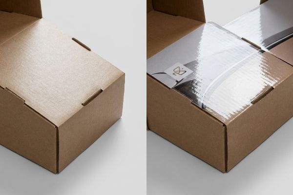 An open brown cardboard box showcasing a product with a glossy, laminated surface and a subtle gold-colored logo, highlighting packaging finish.