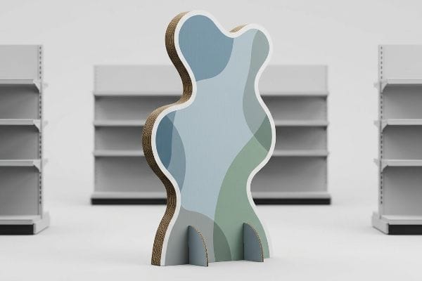 Corrugated cardboard die-cut standee with an organic, wavy shape and blue-green abstract pattern, designed for retail visual disruption.
