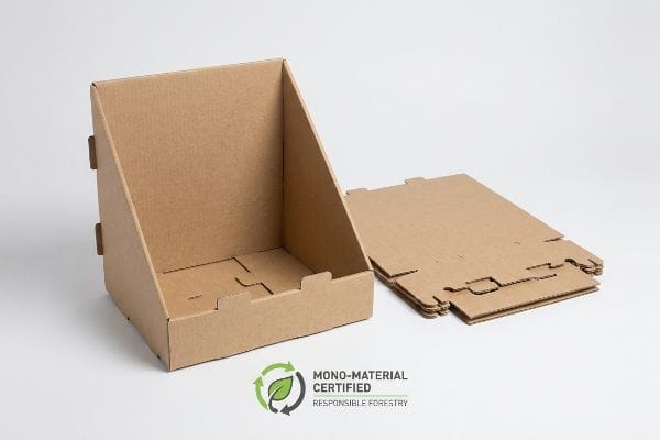 Natural brown corrugated cardboard counter display with Origami-style friction locks, alongside flat-packed units, featuring a Mono-Material Certified Responsible Forestry logo.