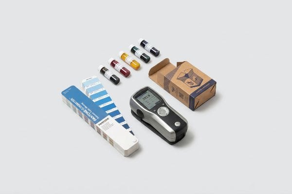 Ensuring accurate color matching with a spectrophotometer, Pantone Geometrik swatches, and pigment samples.