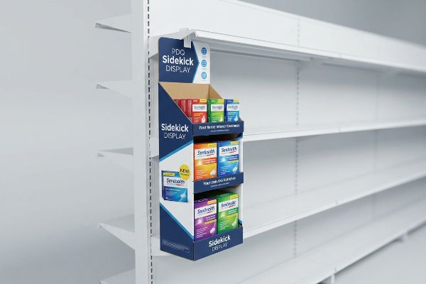 A blue and white PDQ Sidekick Display hangs on a white retail shelf, showcasing various Sensihealth product boxes.
