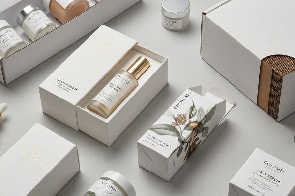 White Colamel Luxury Rigid Box with Youth End Serum, next to a Premium Sbs Board carton and corrugated packaging.