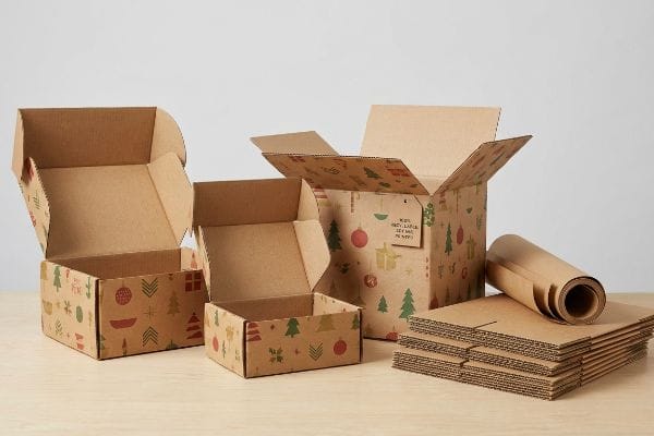 Holiday-themed corrugated boxes and wrapping paper, adorned with festive patterns and a 