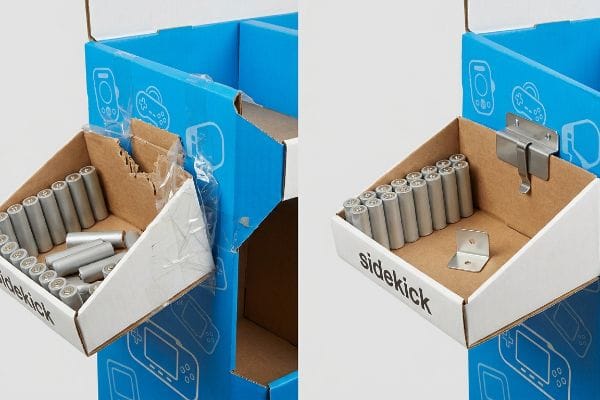 Corrugated sidekick display: torn paper tab with tape vs. universal metal bracket holding batteries.