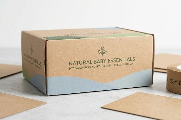 Kraft cardboard box for Natural Baby Essentials, with Soy-Based Inks, Aqueous Finish, and CPSIA Compliant text.