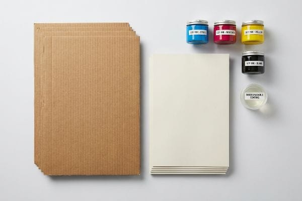 Corrugated cardboard, white paper, Soy Ink in Cyan, Magenta, Yellow, Black, and Biodegradable Coating for displays.