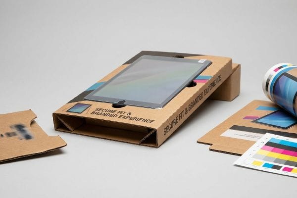 A tablet is securely nestled in a custom-printed corrugated cardboard insert, featuring