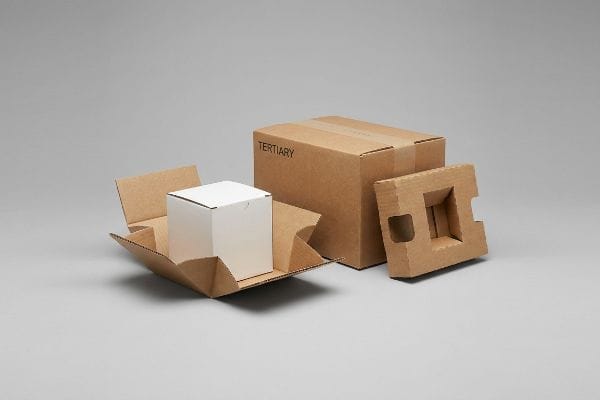 Brown corrugated Tertiary shipping box, ancillary packaging inserts, and a white product box.