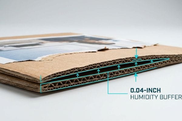 Corrugated cardboard cross-section revealing a 0.04-inch Humidity Buffer, designed to prevent moisture swelling and tearing.