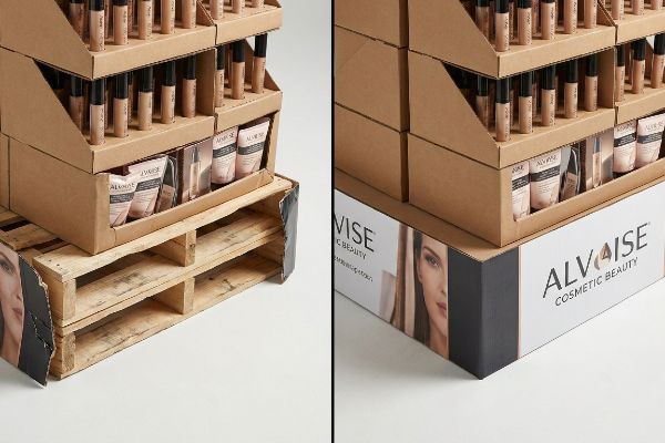 Corrugated cardboard cosmetic display for Alvaise Cosmetic Beauty, featuring foundation tubes and pouches, sits on a wooden pallet with a branded skirt.