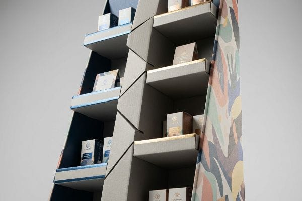 A multi-tiered cardboard POP display with asymmetric shelves, blue and gold metallic trims, holds LUMITY and LA NUIT boxes.