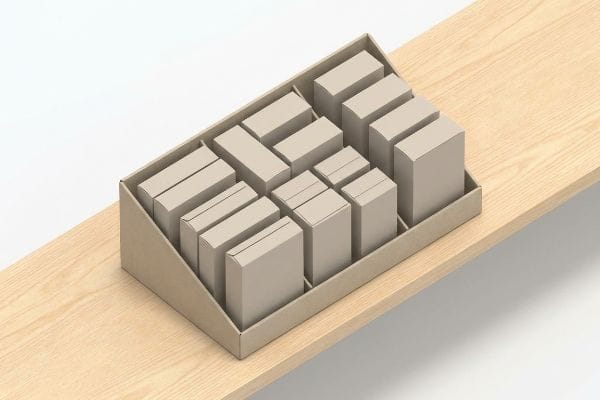 A beige cardboard PDQ display tray filled with unbranded light beige boxes, presented on a light wooden surface.