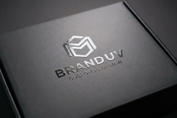 A sleek black box featuring a silver Branduv logo and Custom & Design text, showcasing a raised, glossy spot UV finish.