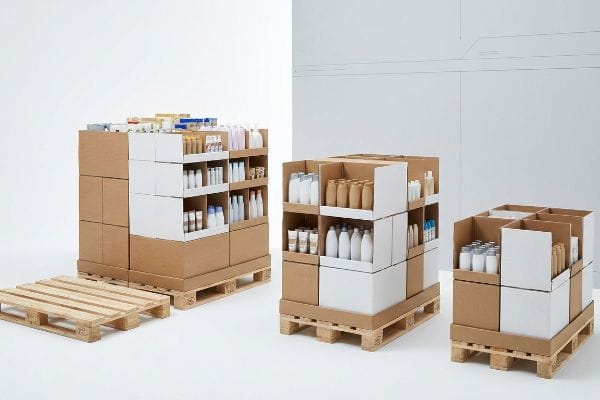 Modular cardboard POP displays with various retail products on fractional GMA wood pallets, alongside an empty pallet.