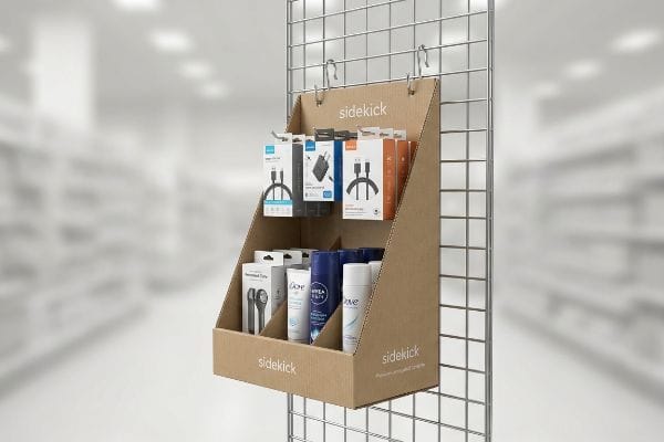 Cardboard Sidekick retail display on a wire rack, merchandising tech accessories, Dove, and Nivea products.