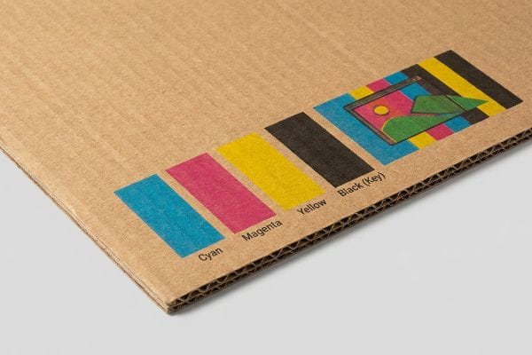 CMYK color bars, Cyan, Magenta, Yellow, and Black (Key), are printed on corrugated cardboard, illustrating print color accuracy.