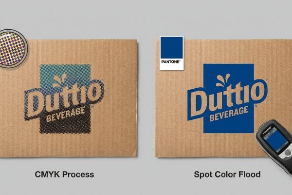Corrugated cardboard shows Duttio Beverage logo: grainy CMYK process halftone dots versus vibrant Pantone spot color flood, measured by spectrophotometer.