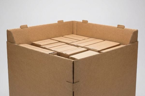 A large corrugated cardboard dump bin, filled with neatly arranged smaller brown cardboard boxes, ready for retail merchandising.